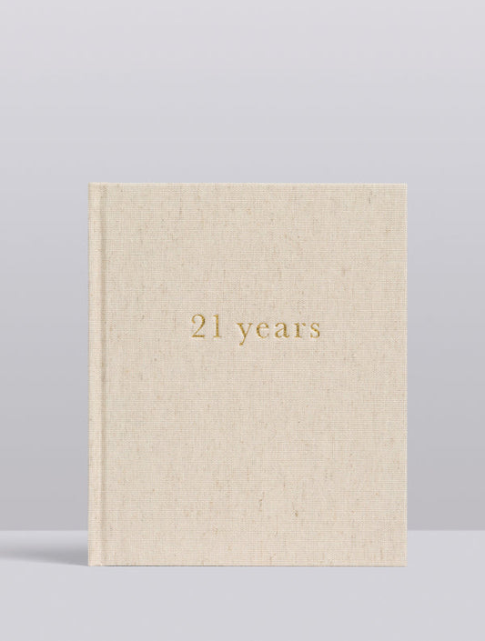 Beige book with '21 years' in gold 