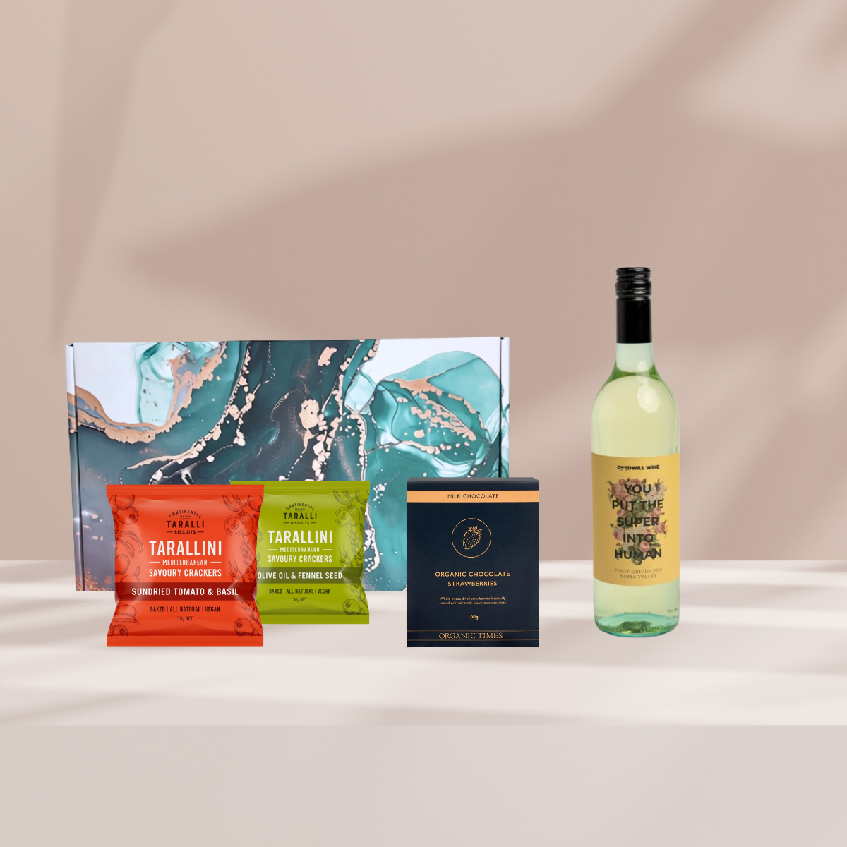Sip & Snack gift hamper featuring Goodwill wine, sun-dried tomato and olive taralli biscuits, and chocolate-covered strawberries.