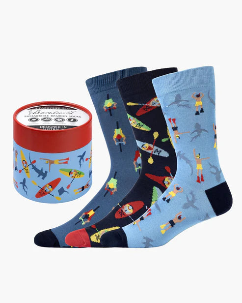 Set of colorful socks with a design of people kayaking, next to a cylindrical container with a brand label.