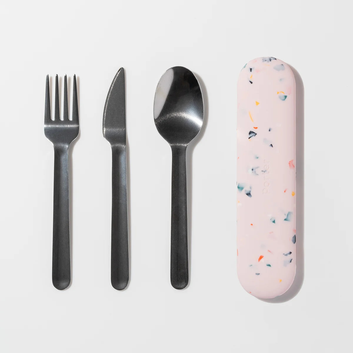 A flat-lay of a four-piece metal cutlery set with a pink terrazzo-patterned protective case on a clean white background.
