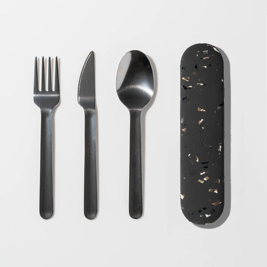 A flat-lay of a four-piece metal cutlery set with a Charcoal  terrazzo-patterned protective case on a clean white background.