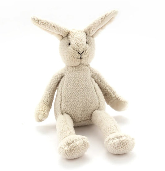 A set of plush baby toys designed to look like cows, with beige, white, and black coloring.