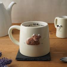 White mug with highland cow design 