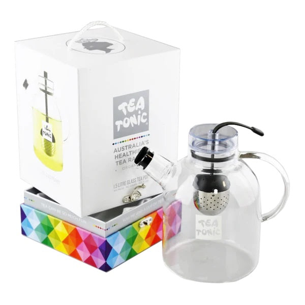 A clear glass teapot with a tea warmer, alongside its colorful box packaging which reads 'TEA TONIC'.
